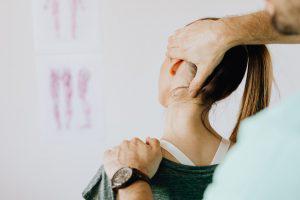 Chiropractor stretching neck of a woman